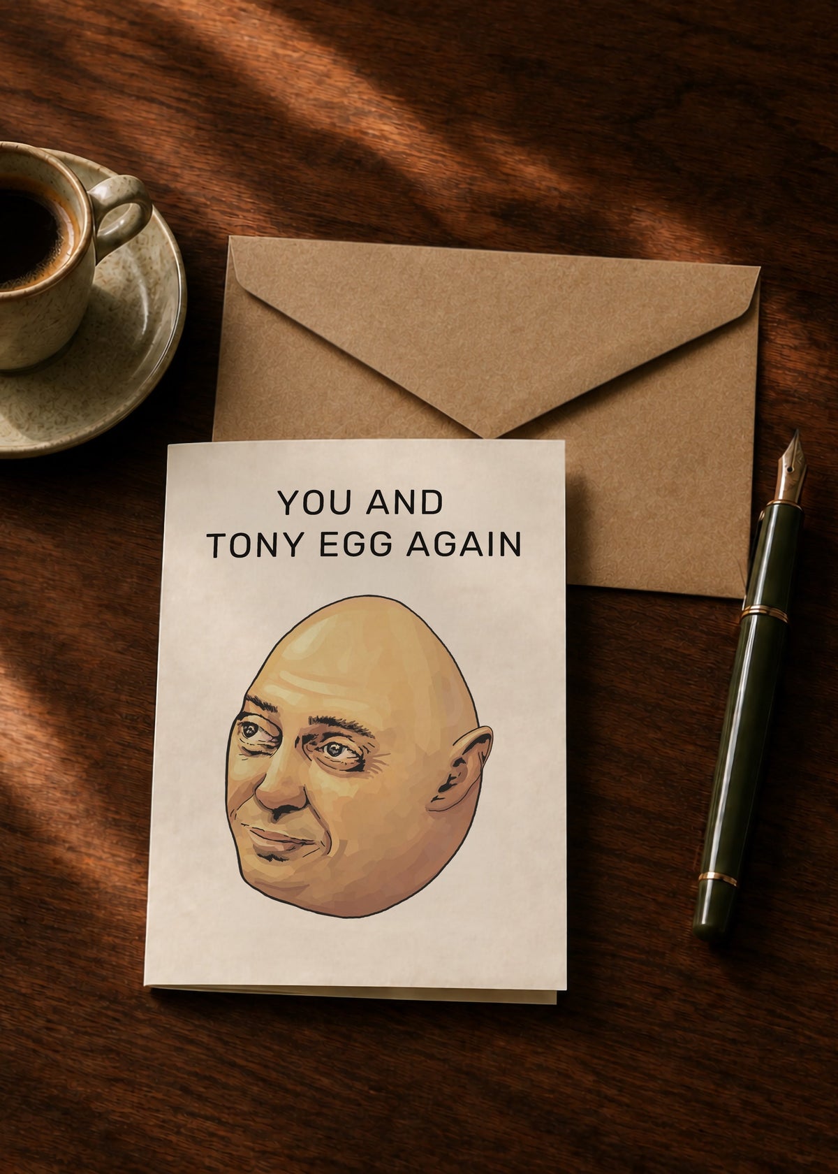 You and Tony Egg Again Sopranos greeting card with kraft envelope, coffee and pen on a dark wooden table.